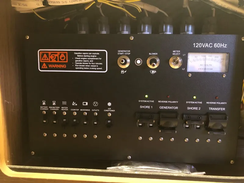 Slide: The Image of Electrical control panel on 2018 Jeanneau NC 895 boat, featuring switches and warning labels. - 36