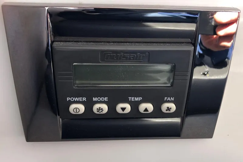 Slide: The Image of Control panel on a 2018 Jeanneau NC 895 boat, featuring power, mode, temp, and fan buttons. - 38