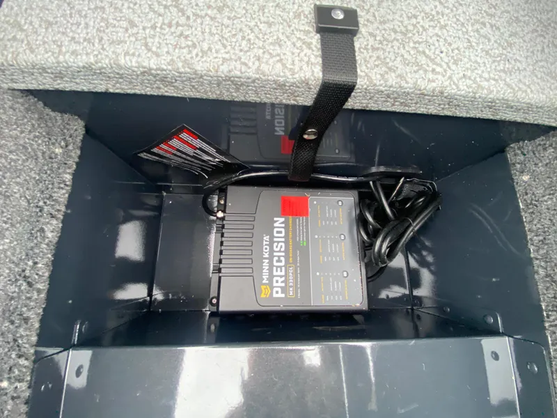 Slide: The Image of Minn Kota Precision charger inside 2025 Lund 1775 Pro Guide boat compartment. - 14