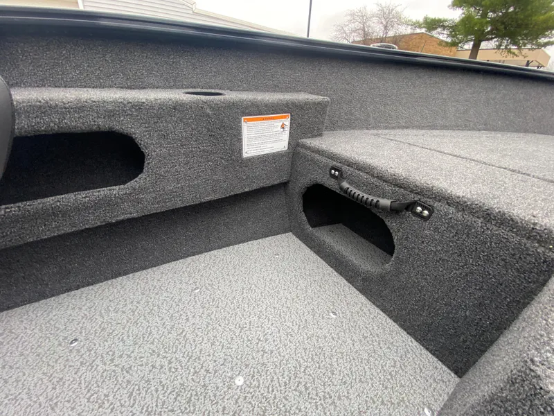 Slide: The Image of 2025 Lund 1775 Pro Guide boat interior with textured flooring and storage compartments. - 15