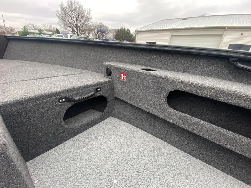 Slide: The Image of 2025 Lund 1775 Pro Guide boat interior with storage compartments and textured flooring. - 16