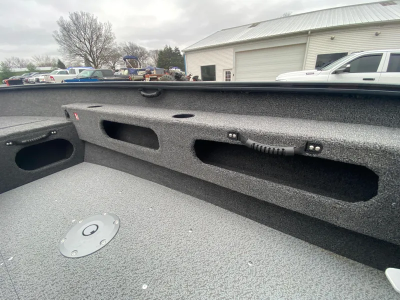 Slide: The Image of 2025 Lund 1775 Pro Guide boat interior with storage compartments and textured flooring. - 17