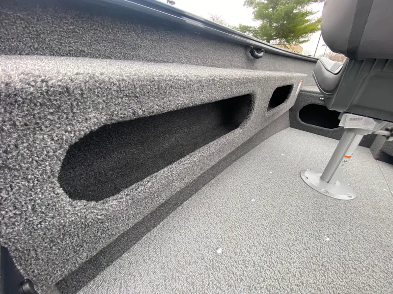 Slide: The Image of 2025 Lund 1775 Pro Guide boat interior with textured flooring and storage compartments. - 18