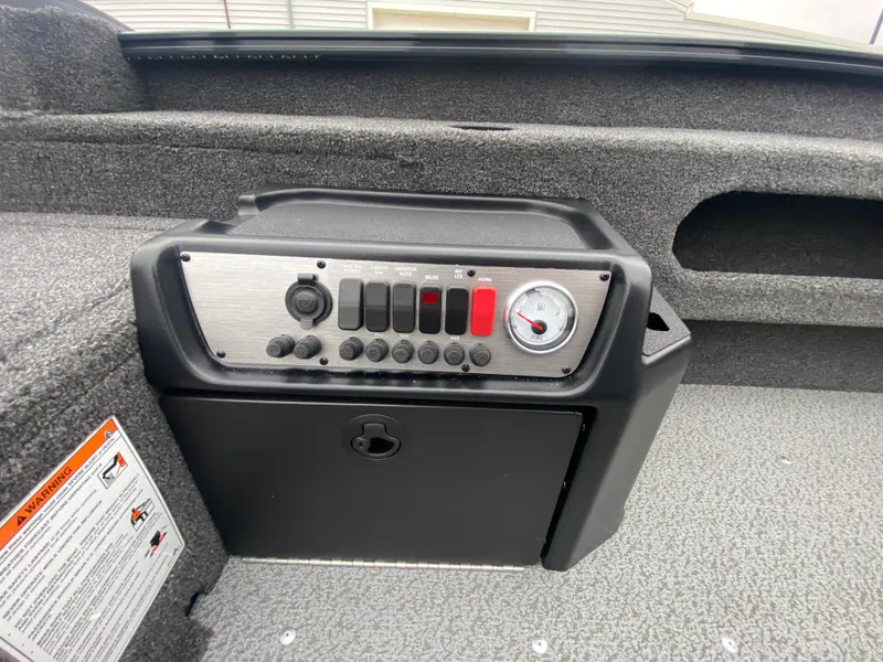 Slide: The Image of 2025 Lund 1775 Pro Guide boat control panel with switches and gauge. - 19
