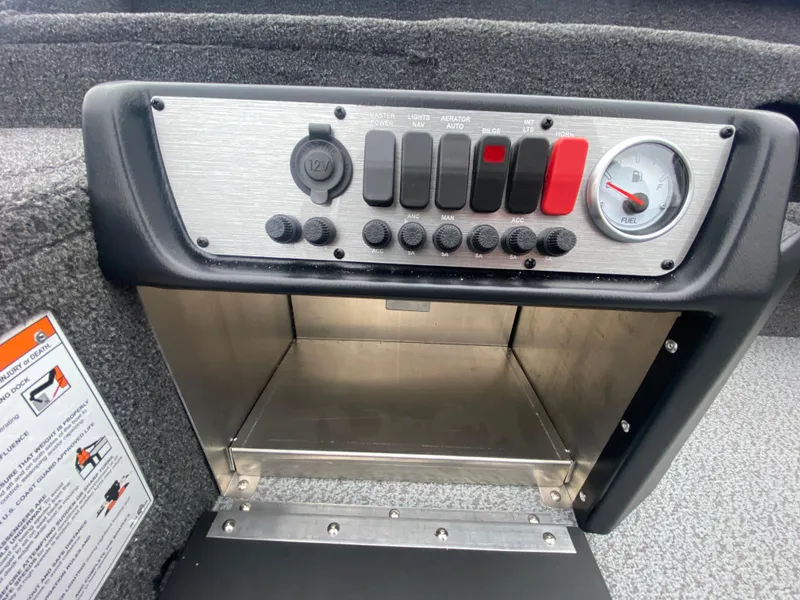 Slide: The Image of 2025 Lund 1775 Pro Guide control panel with switches and gauge. - 20