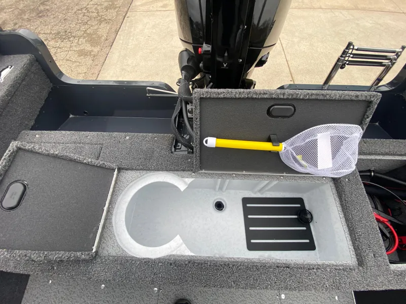 Slide: The Image of 2025 Lund 1775 Pro Guide boat interior with storage compartments and fishing net. - 24