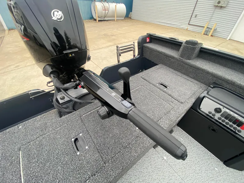 Slide: The Image of 2025 Lund 1775 Pro Guide boat interior with motor and control panel. - 26