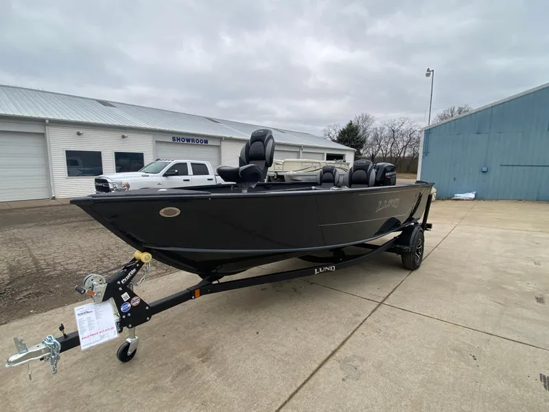 Slide: The Image of 2025 Lund 1775 Pro Guide boat on trailer, parked outside showroom. - 5