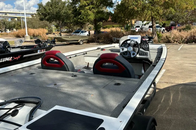 Slide: The Image of 2021 G3 Sportsman 1710 boat with red seats in a parking lot. - 6