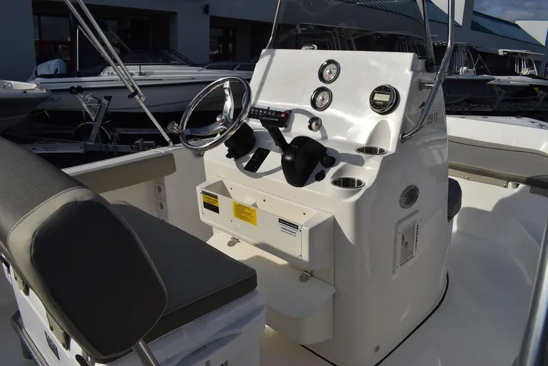 Slide: The Image of 2025 Key West 189 FS boat console with steering wheel and gauges. - 11