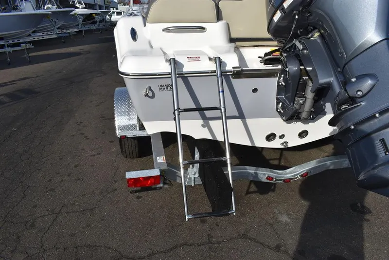 Slide: The Image of 2025 Key West 189 FS boat with ladder and motor on trailer. - 17