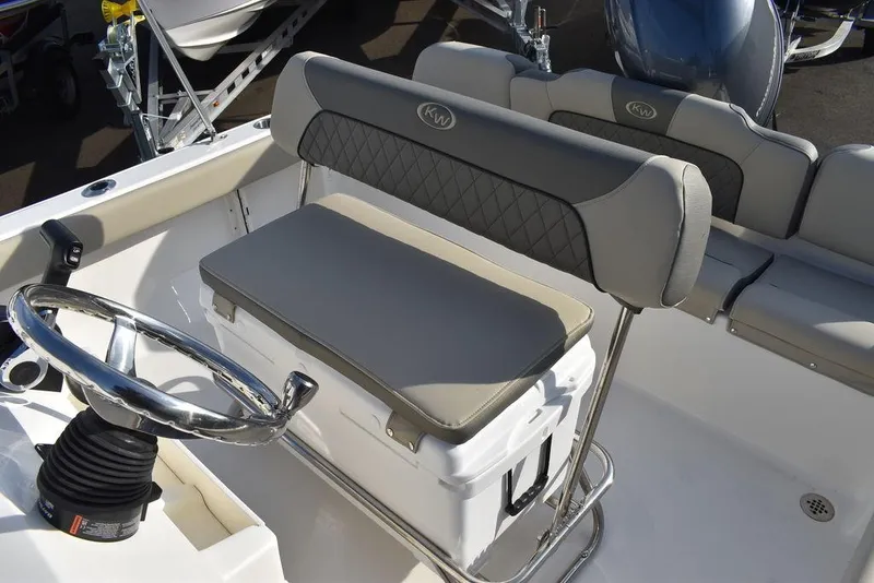 Slide: The Image of 2025 Key West 189 FS boat interior with cushioned seating and steering wheel. - 19