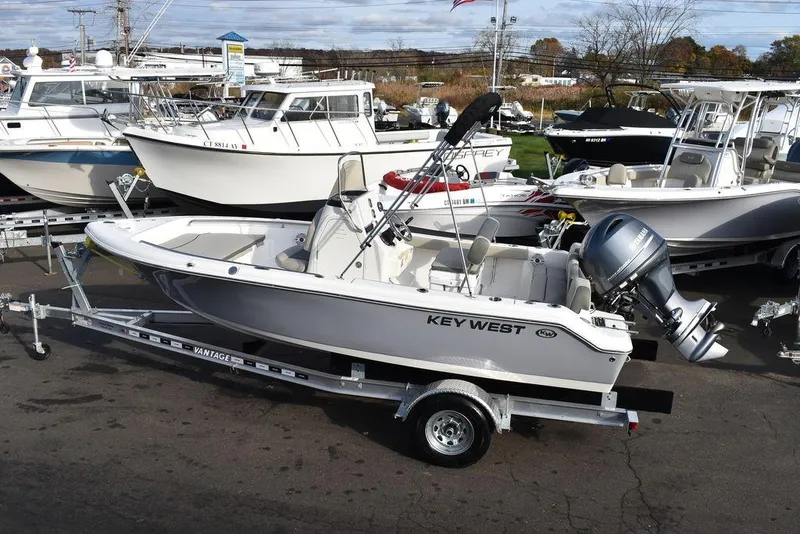 Slide: The Image of 2025 Key West 189 FS boat on trailer, surrounded by other boats in a marina. - 5