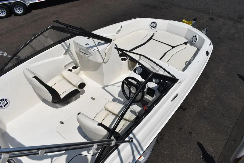 Slide: The Image of 2023 Stingray 191DC boat interior with white seating and steering console. - 10