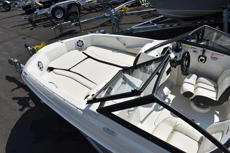 Slide: The Image of 2023 Stingray 191DC boat interior with white seating and steering wheel. - 14