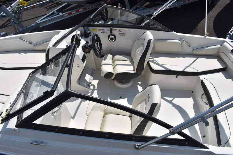 Slide: The Image of 2023 Stingray 191DC boat interior with white seating and steering wheel. - 15