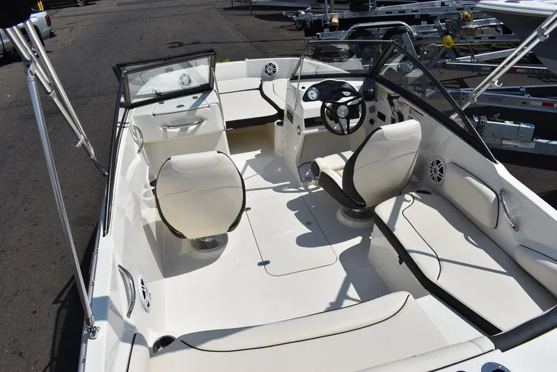 Slide: The Image of 2023 Stingray 191DC boat interior with white seating and steering wheel. - 17