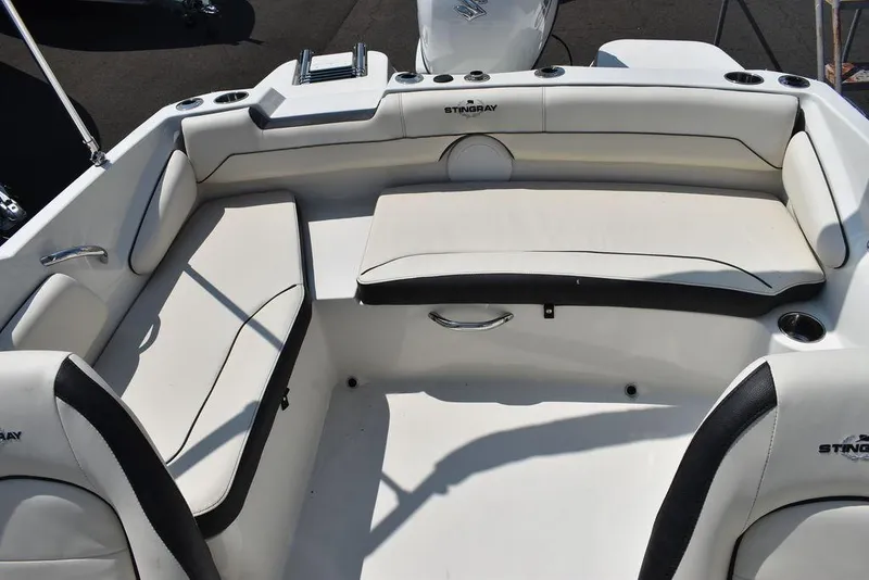 Slide: The Image of 2023 Stingray 191DC boat interior with white seating and modern design. - 18