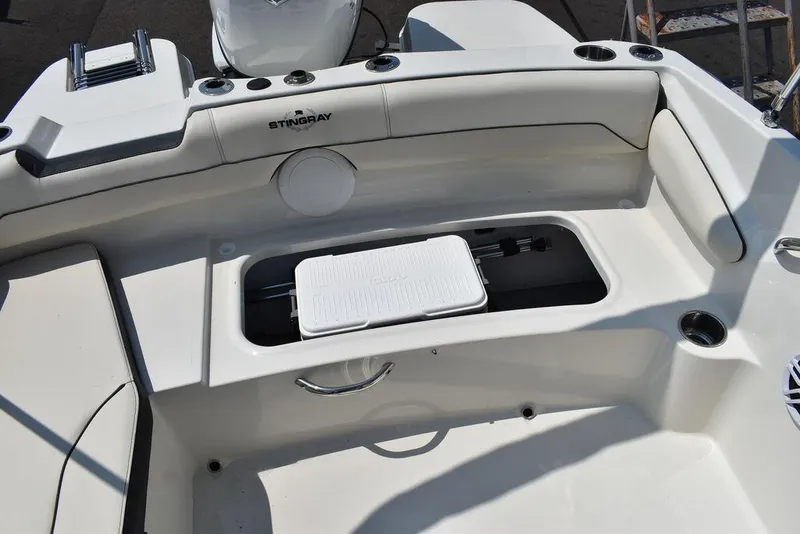 Slide: The Image of 2023 Stingray 191DC boat interior with storage compartment and seating. - 19
