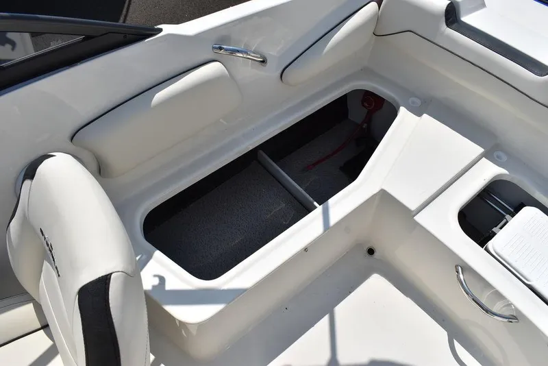 Slide: The Image of 2023 Stingray 191DC boat interior with open storage compartment and seating. - 20