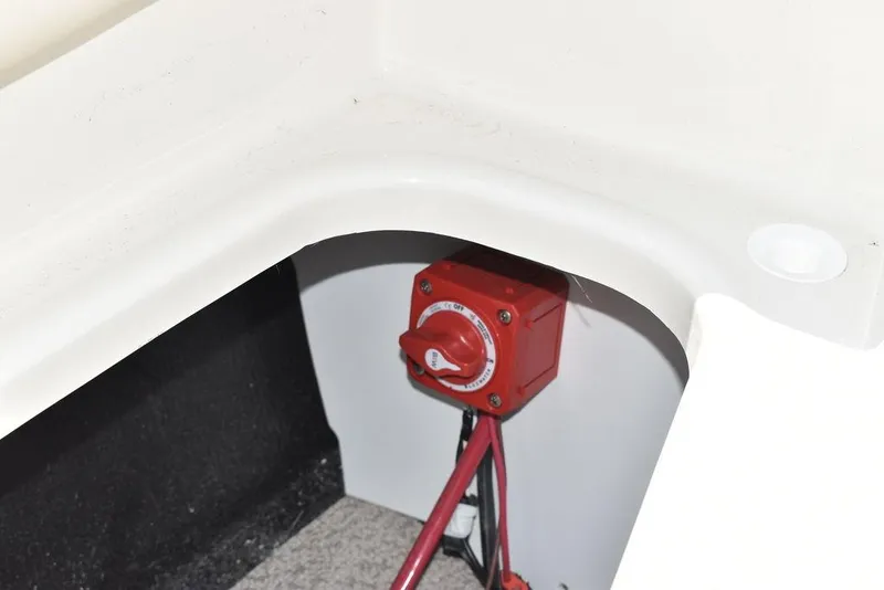 Slide: The Image of 2023 Stingray 191DC boat battery switch in storage compartment. - 21