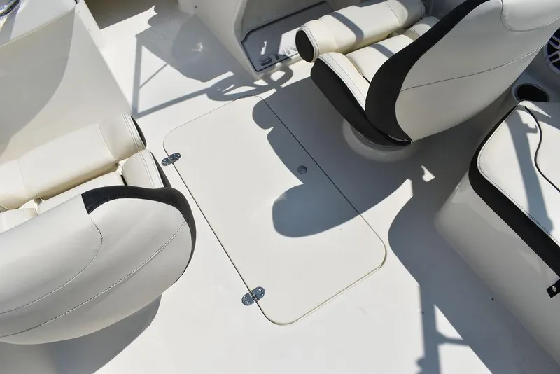 Slide: The Image of 2023 Stingray 191DC boat interior with white seating and storage hatch. - 22
