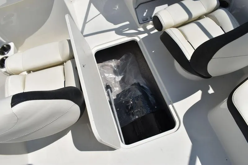 Slide: The Image of 2023 Stingray 191DC boat interior with open storage compartment and white seating. - 23