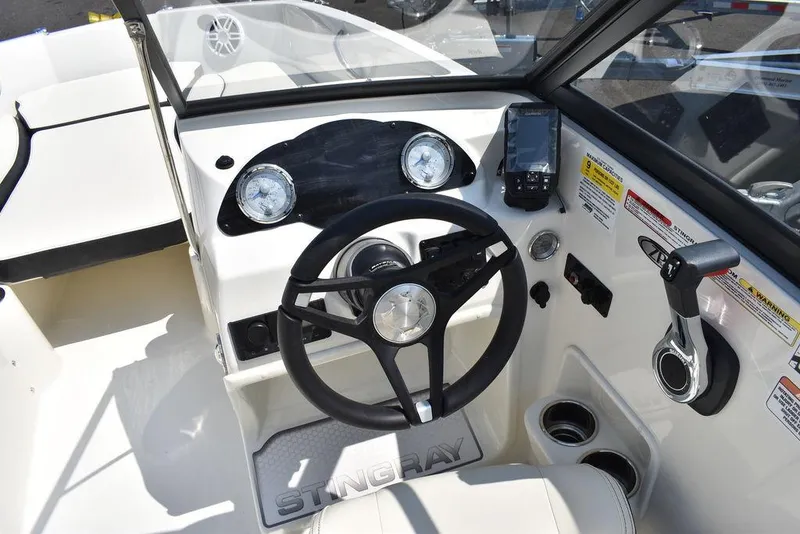Slide: The Image of 2023 Stingray 191DC boat dashboard with steering wheel and controls. - 25