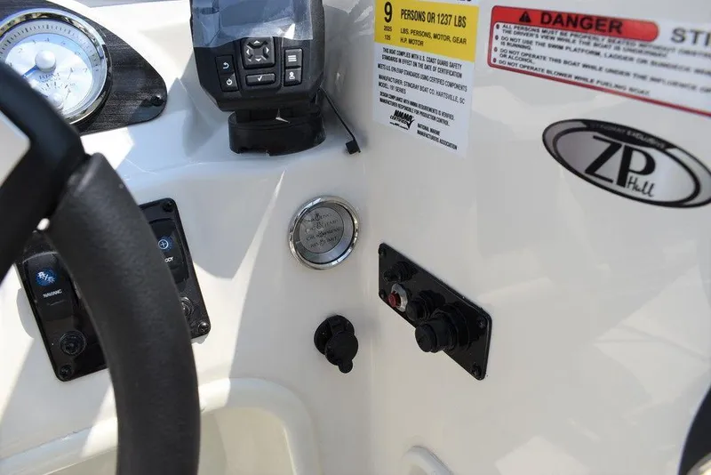 Slide: The Image of 2023 Stingray 191DC dashboard with controls and warning labels. - 28