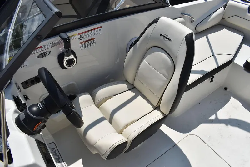 Slide: The Image of 2023 Stingray 191DC boat interior with white leather seating and steering wheel. - 29