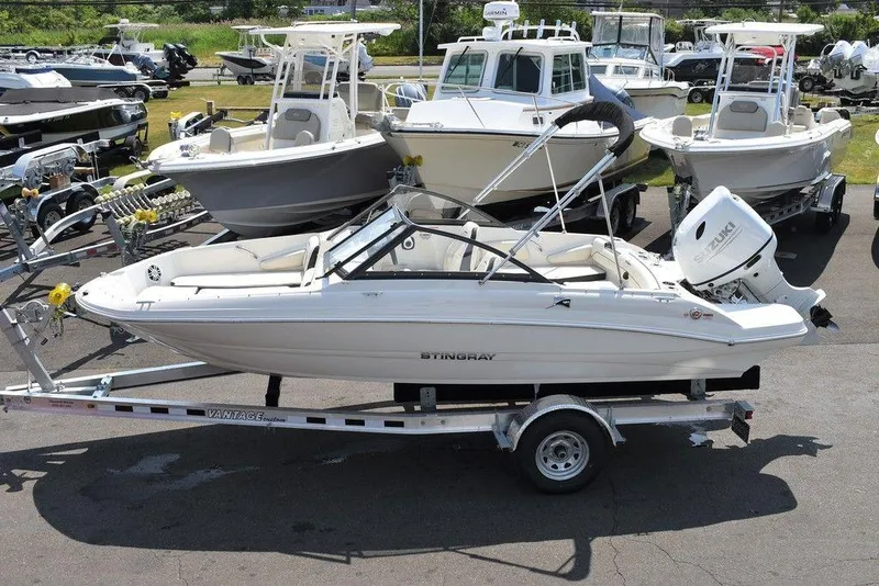 Slide: The Image of 2023 Stingray 191DC boat on trailer, surrounded by other boats in a dealership lot. - 3