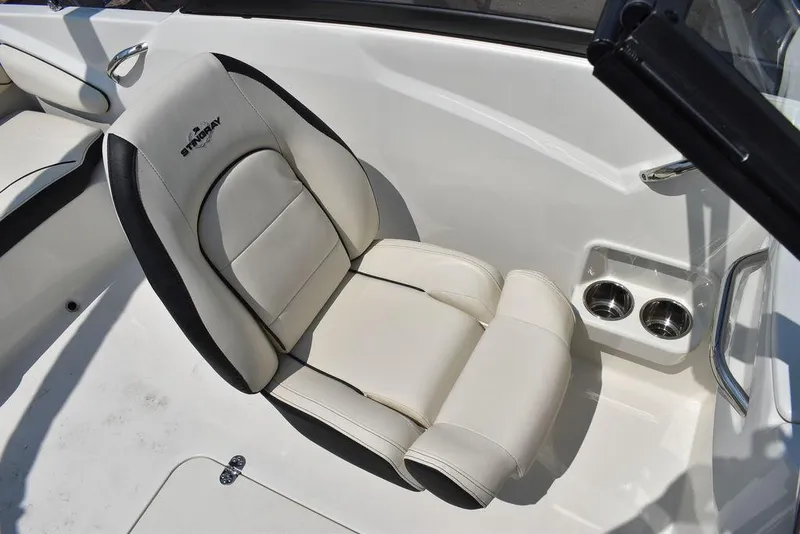 Slide: The Image of 2023 Stingray 191DC boat seat with cup holders, white and black design. - 31