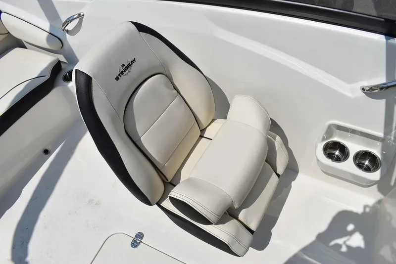 Slide: The Image of 2023 Stingray 191DC boat seat with cup holders, white and black design. - 32