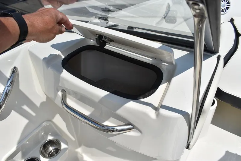 Slide: The Image of 2023 Stingray 191DC boat storage compartment with open lid and stainless steel handles. - 34