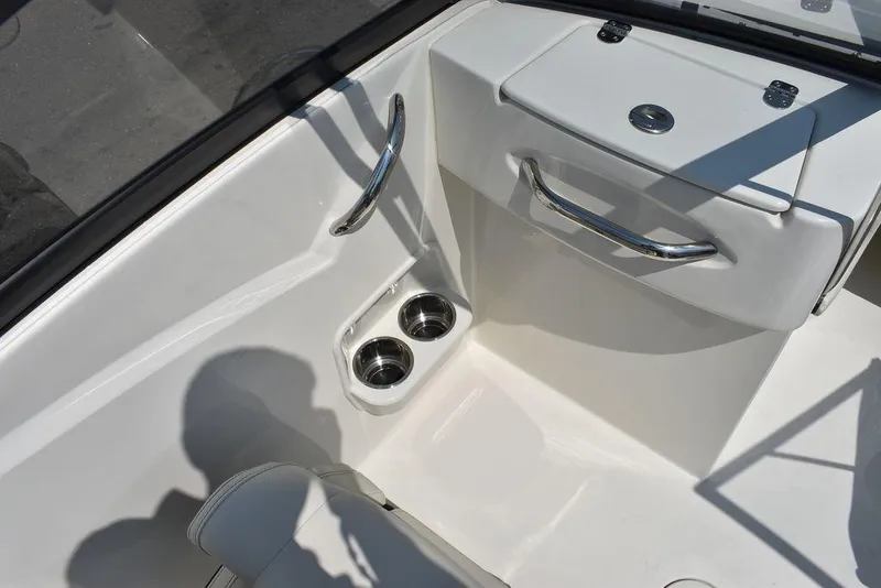 Slide: The Image of 2023 Stingray 191DC boat interior with cup holders and storage compartment. - 35