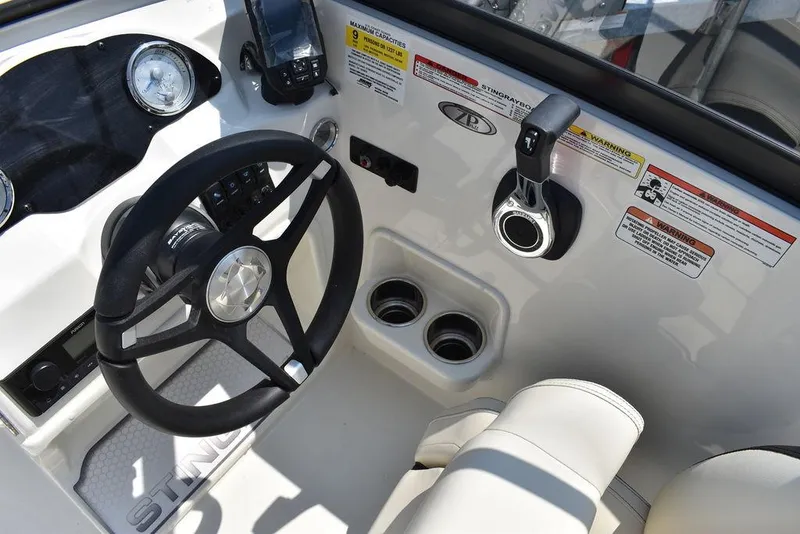 Slide: The Image of 2023 Stingray 191DC boat dashboard with steering wheel and controls. - 36
