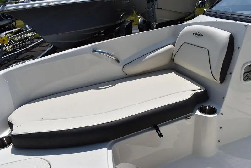 Slide: The Image of 2023 Stingray 191DC boat interior with cushioned seating and cup holder. - 42