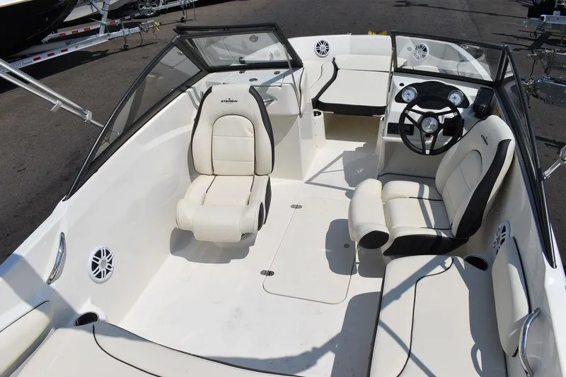 Slide: The Image of 2023 Stingray 191DC boat interior with white seating and steering wheel. - 45