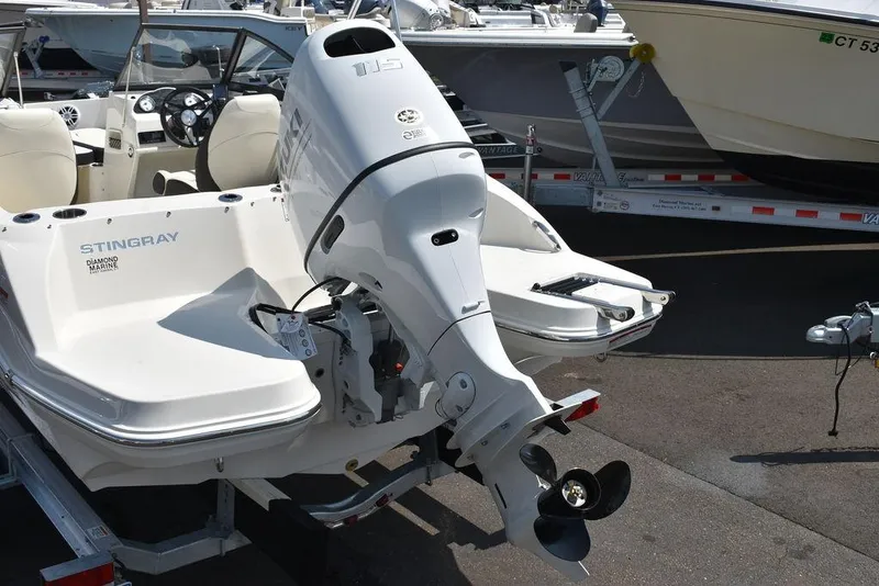 Slide: The Image of 2023 Stingray 191DC boat with outboard motor on trailer. - 5