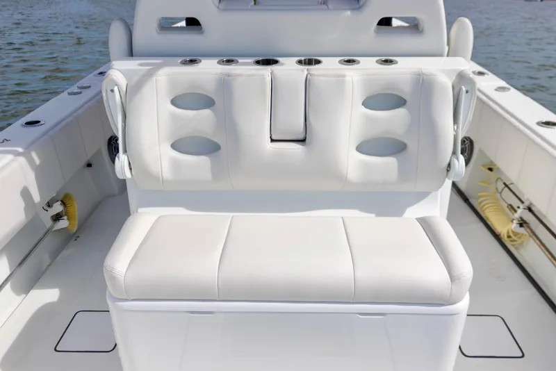 Slide: The Image of 2020 Contender 39 ST boat interior with white cushioned seating. - 10