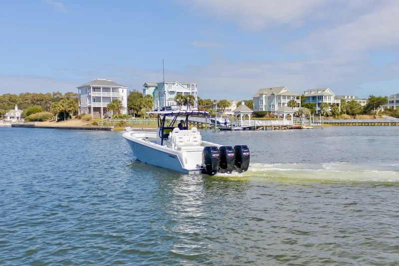 Slide: The Image of 2020 Contender 39 ST boat cruising near waterfront homes. - 2