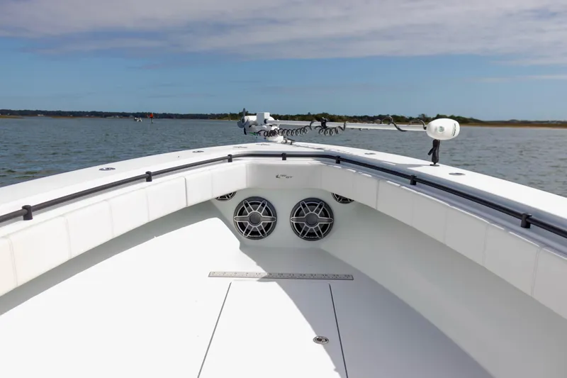 Slide: The Image of 2020 Contender 39 ST boat deck with speakers, on calm water under blue sky. - 6