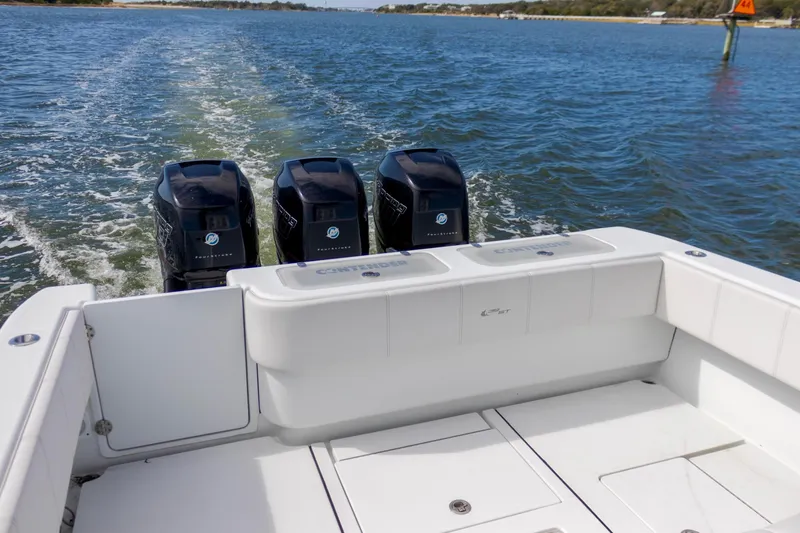 Slide: The Image of 2020 Contender 39 ST boat with triple outboard engines on open water. - 9