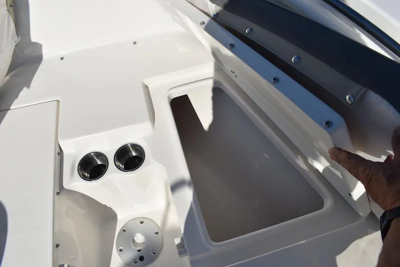 Slide: The Image of 2025 Key West 203 FS boat interior with storage compartment and cup holders. - 10