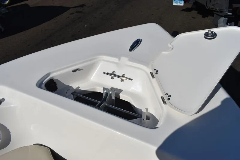Slide: The Image of Key West 203 FS 2025 boat anchor storage compartment with open hatch. - 13