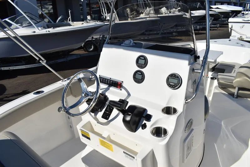 Slide: The Image of Key West 203 FS 2025 boat console with steering wheel and gauges. - 19
