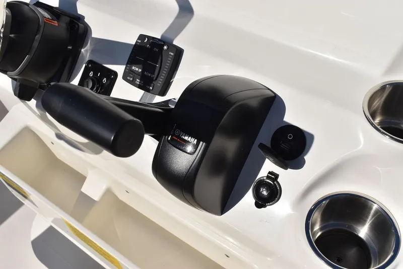 Slide: The Image of Key West 203 FS 2025 boat controls with Yamaha throttle and cup holders. - 23