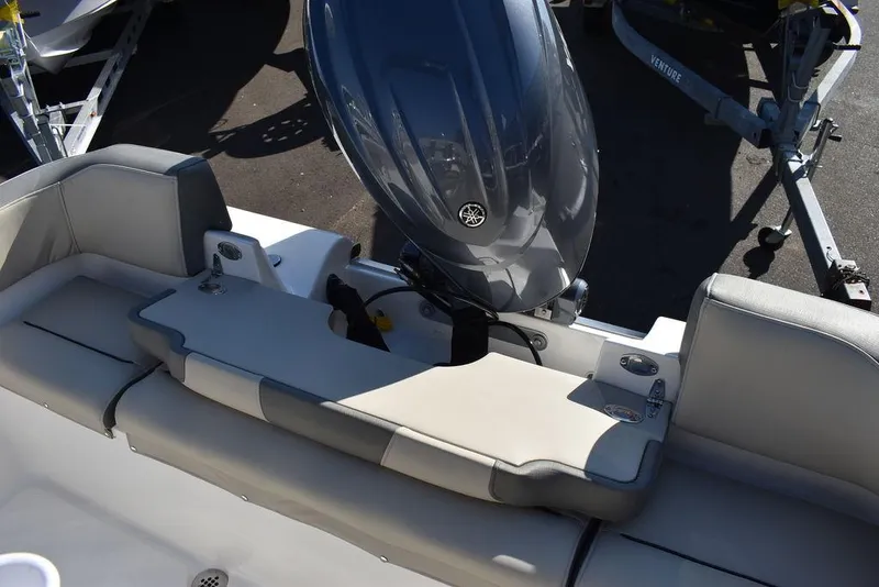 Slide: The Image of 2025 Key West 203 FS boat with outboard motor and cushioned seating. - 30