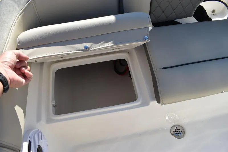 Slide: The Image of Key West 203 FS 2025 boat seat storage compartment open, showcasing interior space. - 33