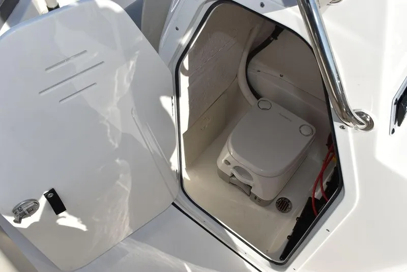 Slide: The Image of 2025 Key West 203 FS boat interior with compact marine toilet. - 39